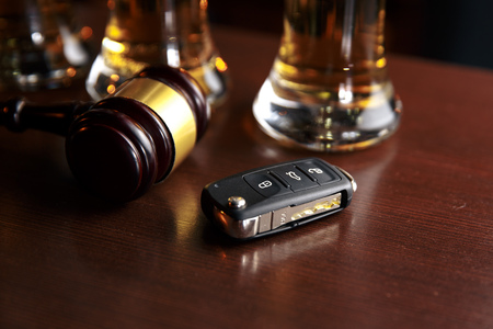 Drinking and driving concept. Car key on a wooden table, pubの写真素材