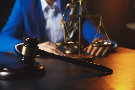 justice and law concept.Male lawyer in the office with brass scale on wooden table,の写真素材