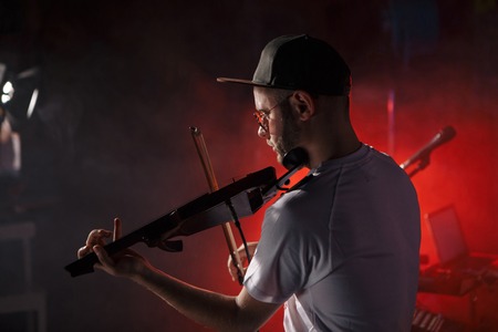 Close-up photo of man playing electric violinの写真素材
