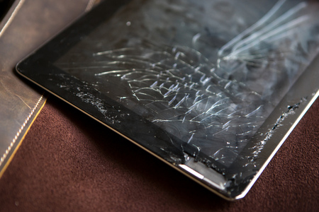 Tablet computer with broken glass screenの写真素材