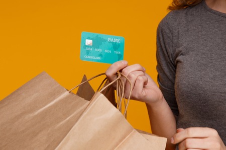 Photo of blue credit card in a girl hand