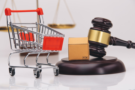 Auction wooden hammer on stand isolated on white. Element for auctions that helps to sell things by hitting the stand.の写真素材