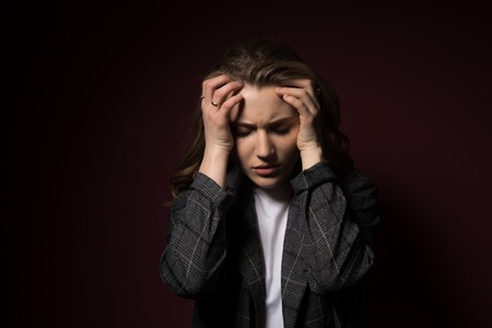 Health And Pain. Stressed Exhausted Young Woman Having Strong Tension Headache. Closeup Portrait Of Beautiful Sick Girl Suffering From Head Migraine, Feeling Pressure And Stress.の写真素材