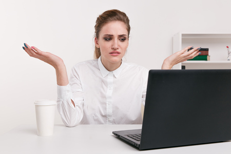 Young attractive woman at modern office desk, working on laptop, massaging temples to forget about constant headaches, noisy loud office giving a migraine, relieving stress, chronic pain, help soothe Young attractive woman at modern office desk, working on laptop, massaging temples to forget about constant headaches, noisy loud office giving a migraine, relieving stress, chronic pain, help soothe