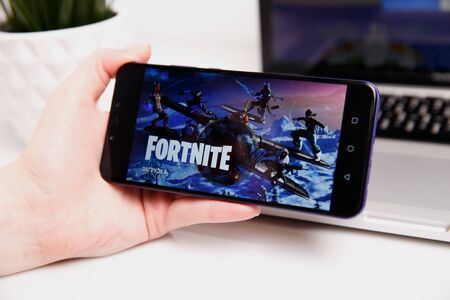 Tula, Russia - February 18, 2019: Fortnite video game screen with character and console controller. Fortnight Battle Royale online gaming by Epicのeditorial素材