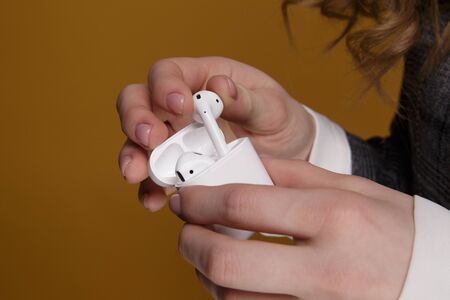 Tula, Russia - JANUARY 24, 2019: Happy woman listening music Apple AirPods wireless .のeditorial素材