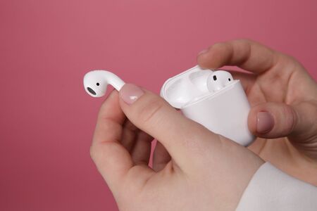 Tula, Russia - JANUARY 24, 2019: Happy woman listening music Apple AirPods wireless .のeditorial素材