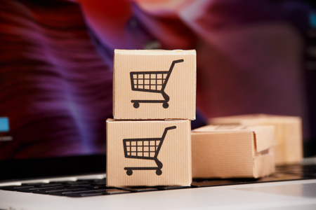 Online shopping . ecommerce and delivery service concept : Paper cartons with a cart or trolley logo...