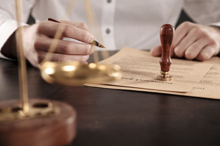 Close up lawyer businessman working or reading lawbook in office workplace.の写真素材