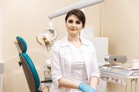 Closeup photo of female doctor in the dentist cabinet.の写真素材