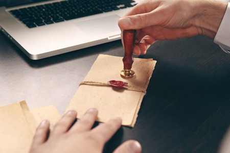 Male attorney stamping document. Seal on notarized paperwork.の写真素材