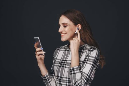 Tula, Russia - JANUARY 24, 2019: Happy woman listening music Apple AirPodsのeditorial素材