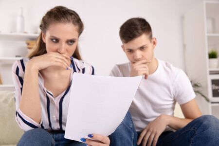 Smiling lawyer, realtor or financial advisor handshaking young couple thanking for advice, insurance...