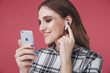 Tula, Russia - JANUARY 24, 2019: Happy woman listening music Apple AirPods