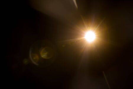 Abstract Natural Sun flare on the blackの写真素材