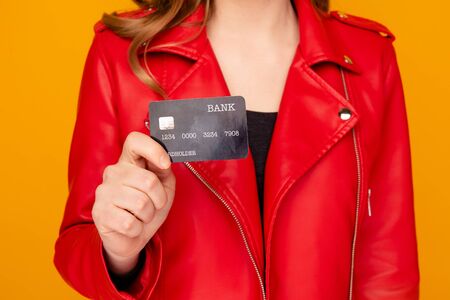 Closeup view of woman holding black credit card isolated.の写真素材