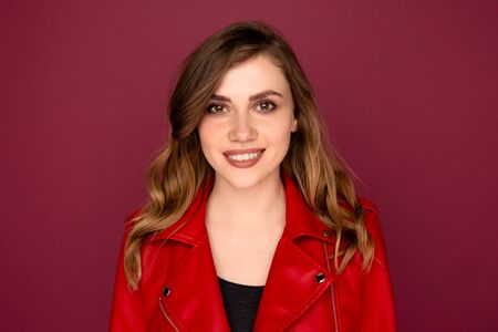 Closeup portrait of handsome young girl smiling on the camera in a studio.