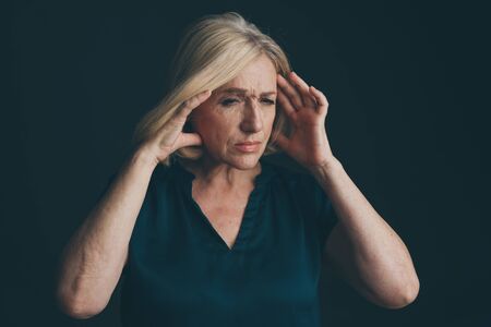 Woman in stress having headache. Migraine concept.の写真素材