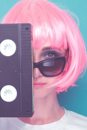 Young girl 90s and VHS cassette on