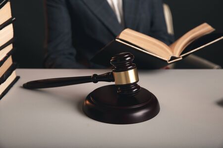 Woman judje isolated in office with books and justice scales and wooden gavel