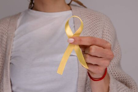 Yellow ribbon in the hand. Sarcoma conceptの写真素材