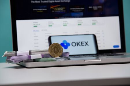 Tula, Russia 17. 06 2019 Okex on the laptop and phone display.のeditorial素材