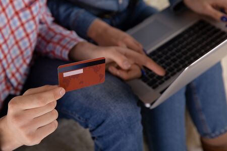 Couple online shopping concept. Credit card in the hand. Using computer.の写真素材