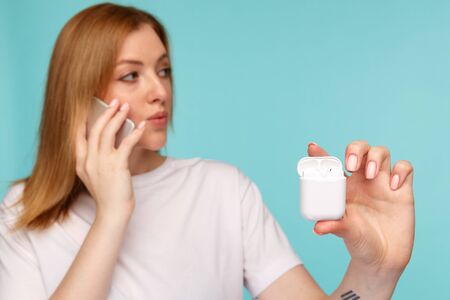 Tula, Russia - JANUARY 24, 2019: Happy woman listening music Apple AirPods wirelessのeditorial素材