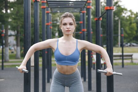 Woman doing exercises in the park. Training on the nature concept.
