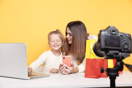 Mother with daughter blogger making video for blog togehter.の写真素材