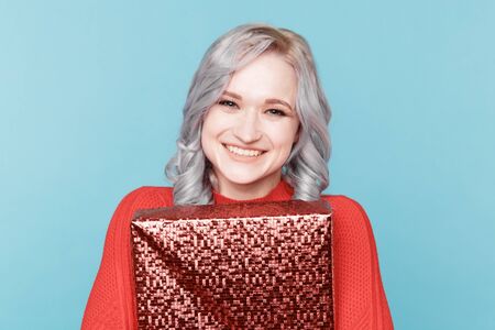Portrait of happy santa woman hugs gift box isolated.の写真素材