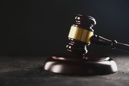 Law and justice concept. Dark gavel on the wooden table.