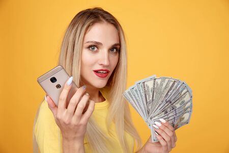 Young female holding dollar cash isolated.