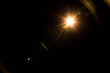 abstract lens flare red light over black
