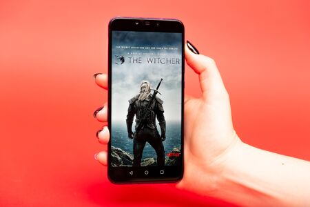 26 08 2019 Tula: The Witcher on the phone display on the red background.のeditorial素材