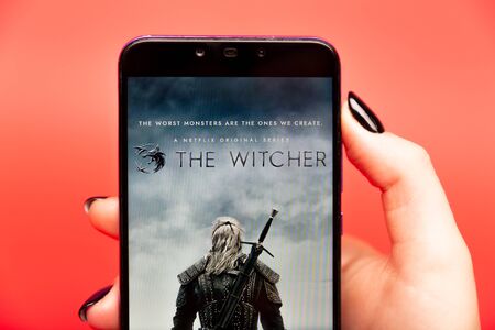 26 08 2019 Tula: The Witcher on the phone display on the red background.のeditorial素材