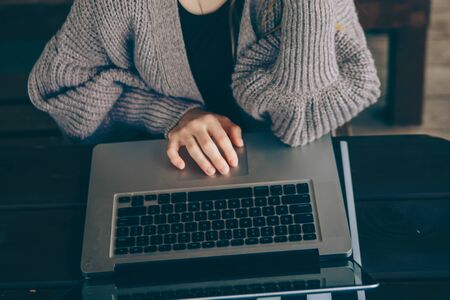 Happy hipster young woman working on laptop in the park