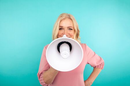 Closeup view of woman with loudspeaker isolated.