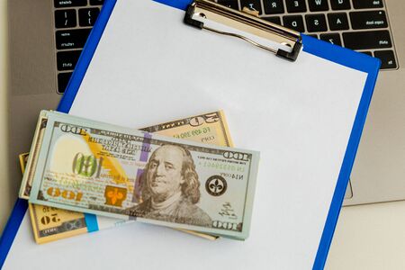 The empty document in statement form and money on the table isolated.の写真素材