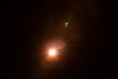 Abstract Natural Sun flare on the black background.の写真素材