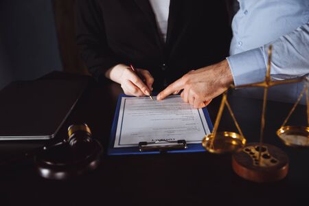 Business - meeting in an office, lawyers or attorneys discussing a document or contract agreementの写真素材