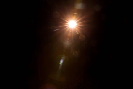 Abstract Natural Sun flare on the black background.