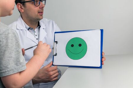 Psychologist counceling child in the cabinet.の写真素材