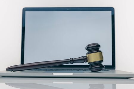 Workspace of lawyer with laptop blank white screen and law wooden gavel,legal book and brass scale...