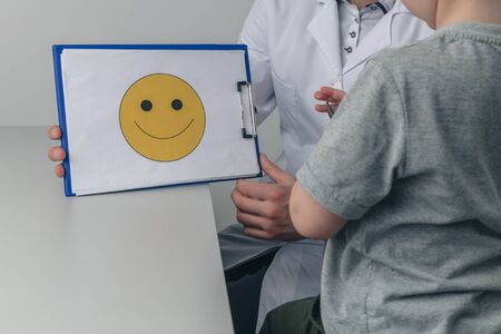 Psychologist therapy. Doctor and kid in the cabinet.