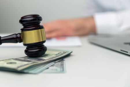 Legal alimony concept. Closeup view of wooden gavel and money.