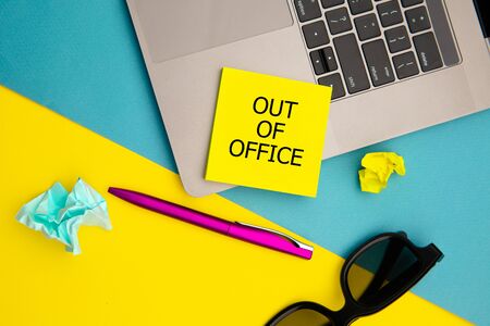 Out of office, message on yellow sticky note. Work from home conceptの写真素材