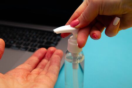 Laptop keyboard and alcohol spray for prevention Coronavirus disease (COVID-19). Healthcare concept