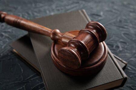 Judges hammer and legal book on a table. Justice concept