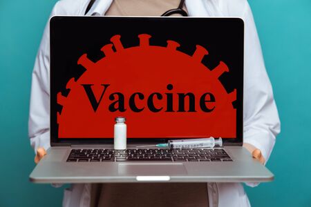 Concept of preparing vaccine from COVID-19 on the laptop screen.の写真素材